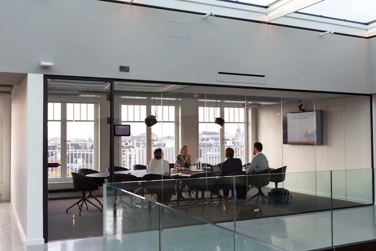 Colleagues discussing work around a meeting table